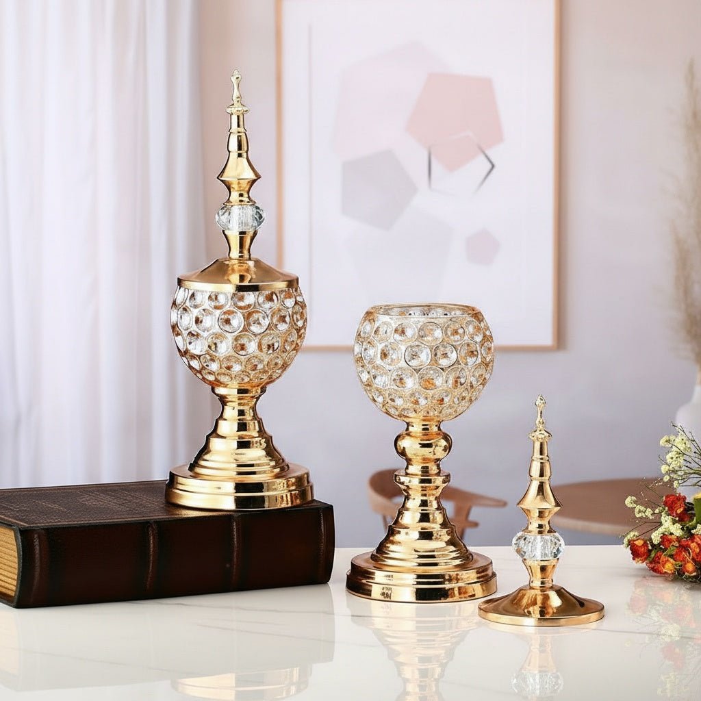 Group display of gold crystal ornaments on a marble surface