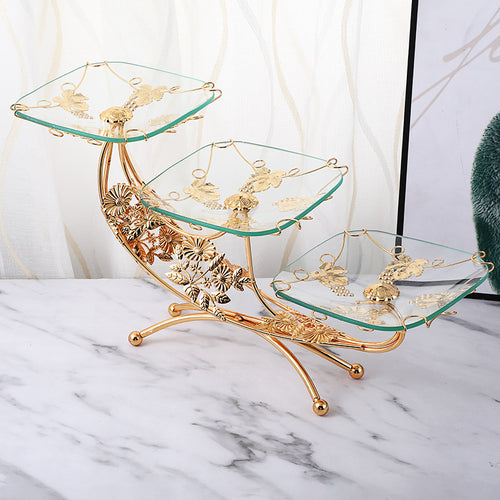 Side view of gold floral metal frame serving stand with three glass tiers