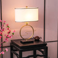 Angled view of gold circle lamp showing fabric shade detail