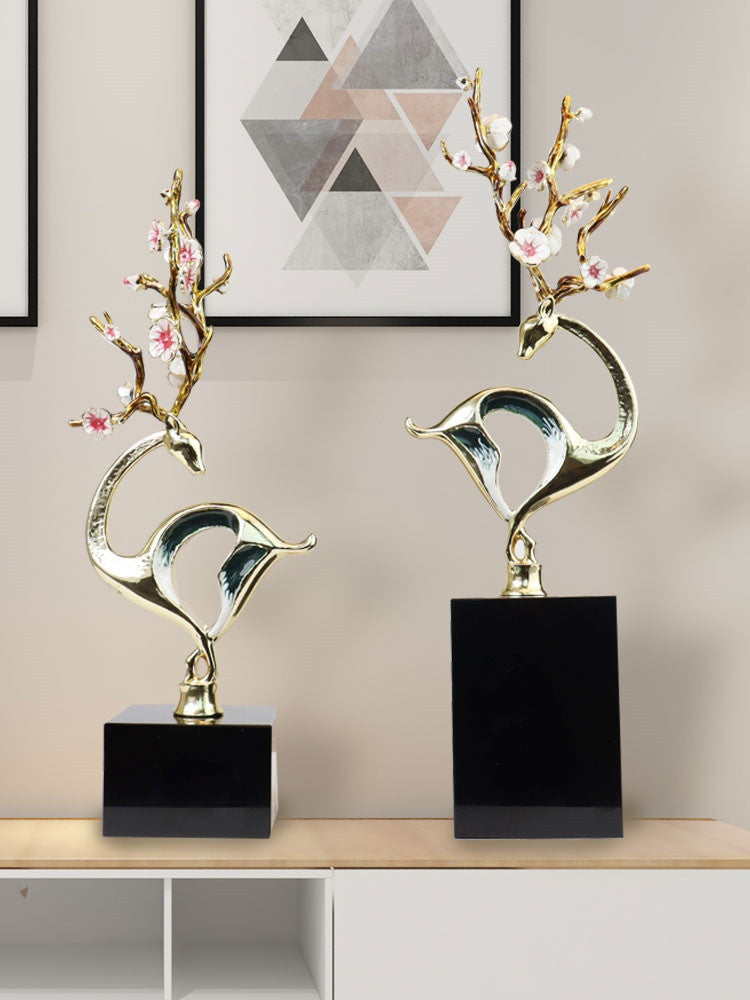 Styled interior shot of gold deer sculptures on console