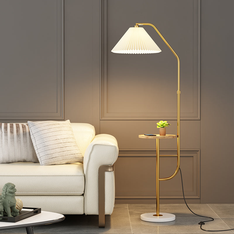 Gold metal arched floor lamp with integrated table in living room setting