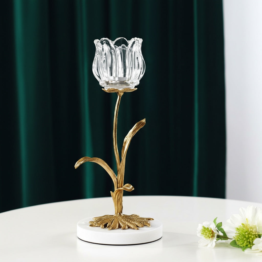 Gold-finished metal stem and glass tulip candle holder on marble base