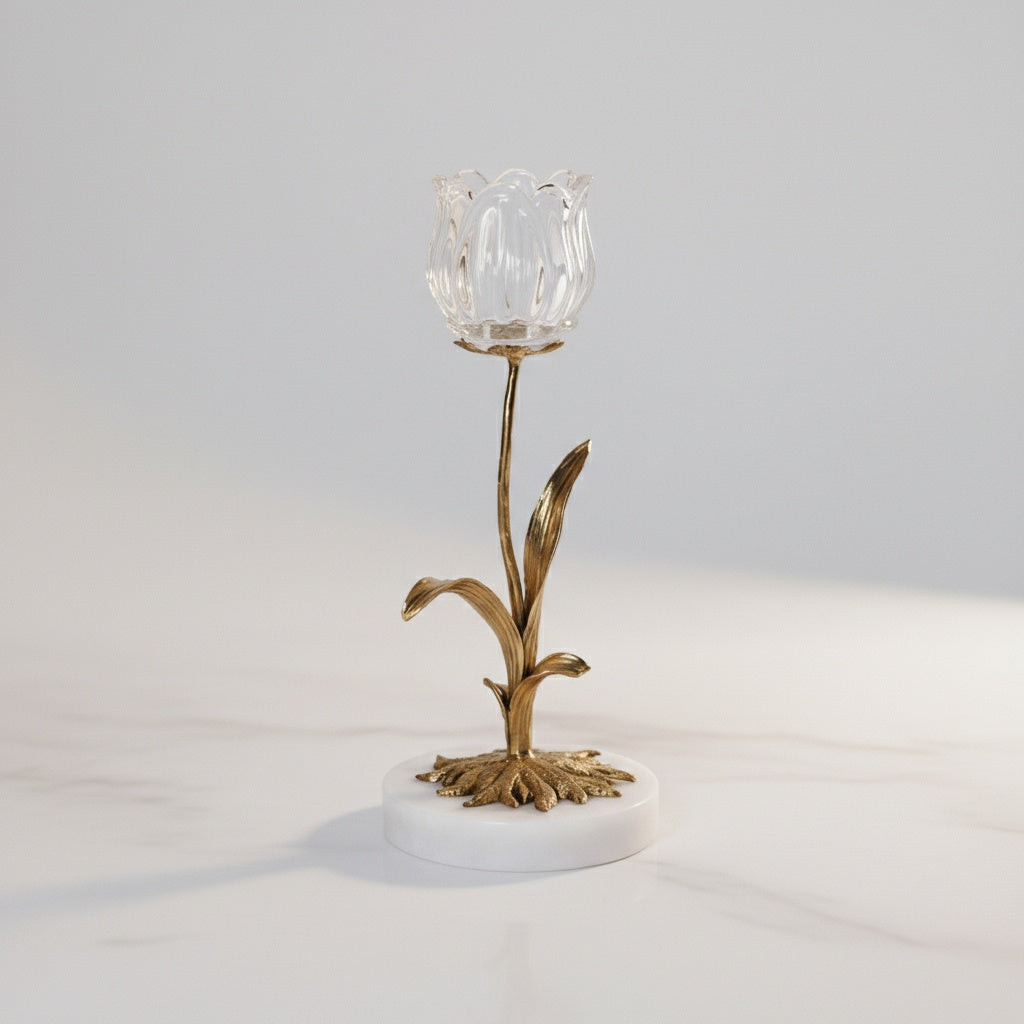 Front view of floral gold metal candle holder with glass cup