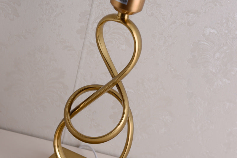 Detail of gold twisted metal lamp body and socket