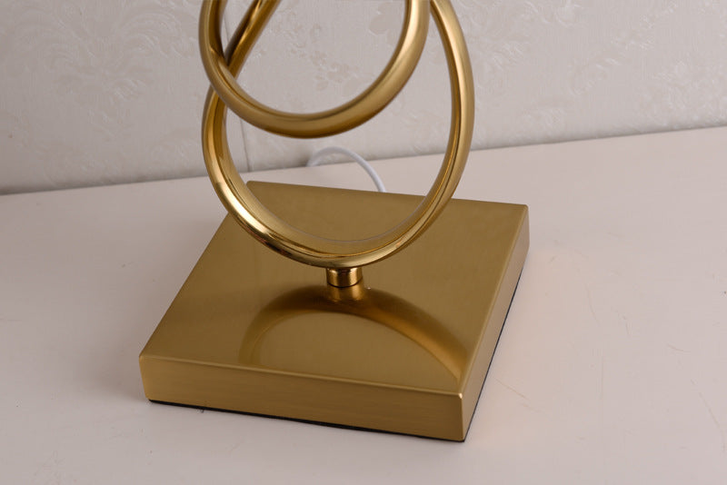 Close up of square gold metal lamp base