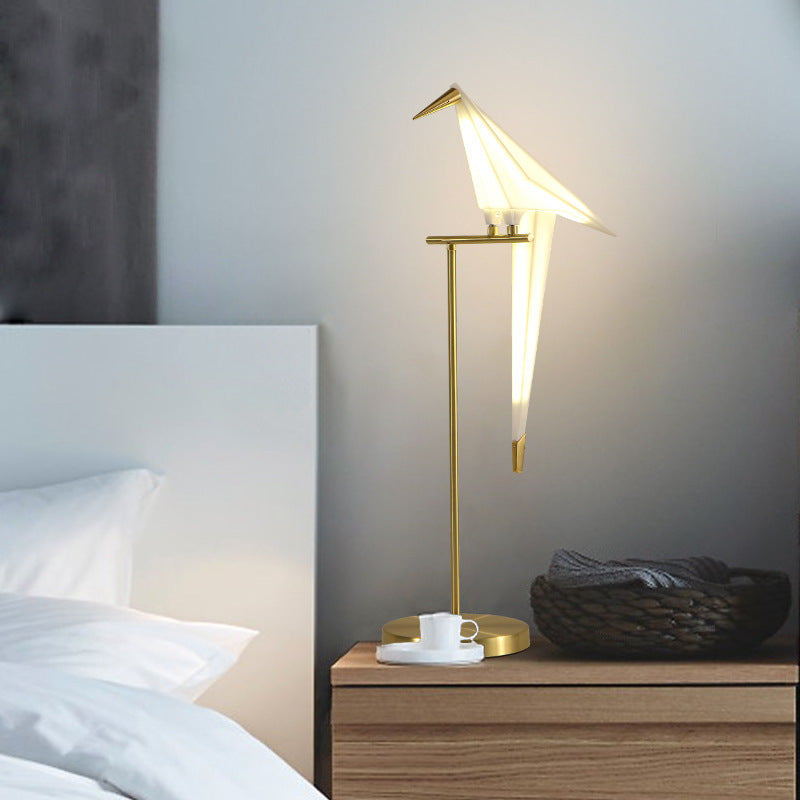Origami bird lamp on bedside table lifestyle