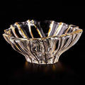 Front view of gold rimmed crystal scalloped centerpiece bowl on black background