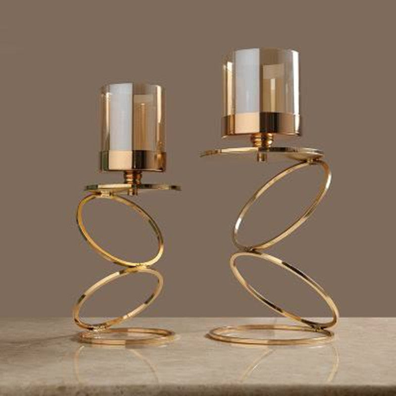 Two gold spiral candle holders in medium and large sizes side by side
