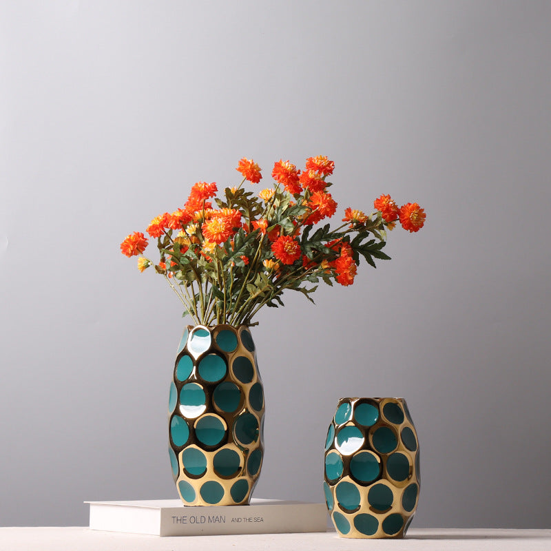 Gold and teal ceramic vase with flowers