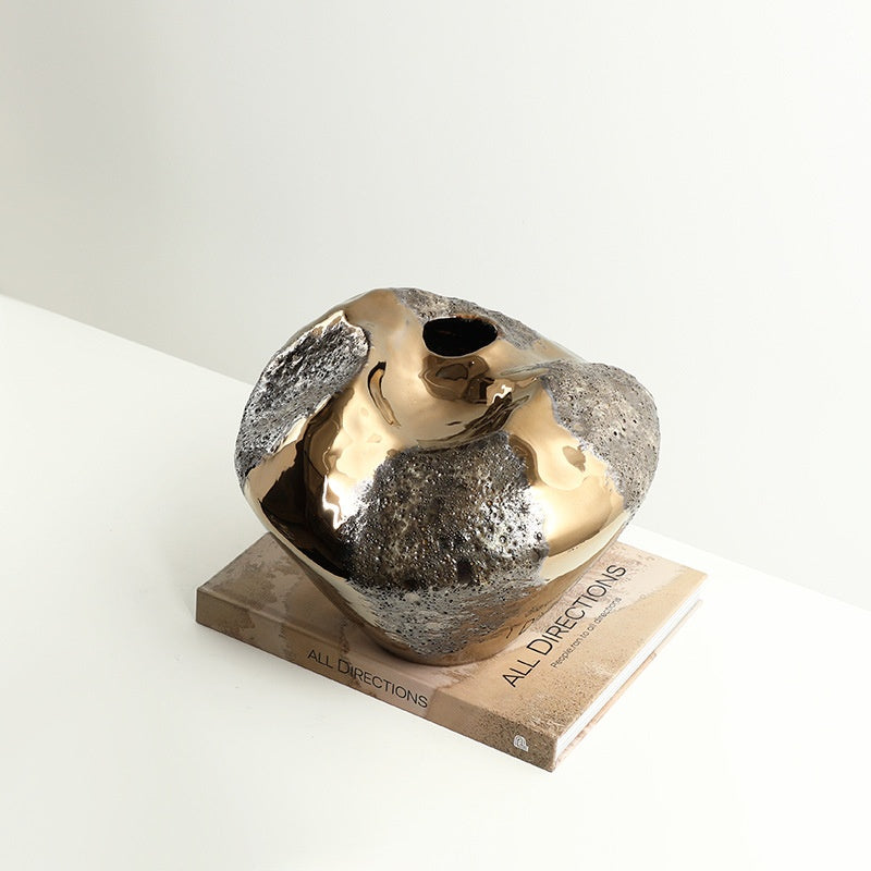 Side view highlighting rough volcanic texture against polished gold