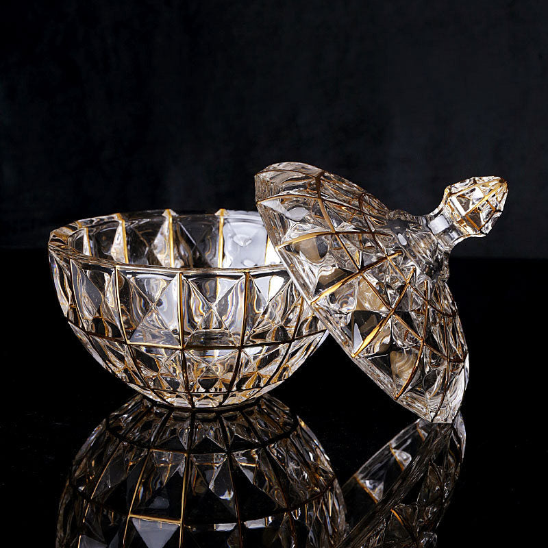 Open lidded glass canister with gold grid details