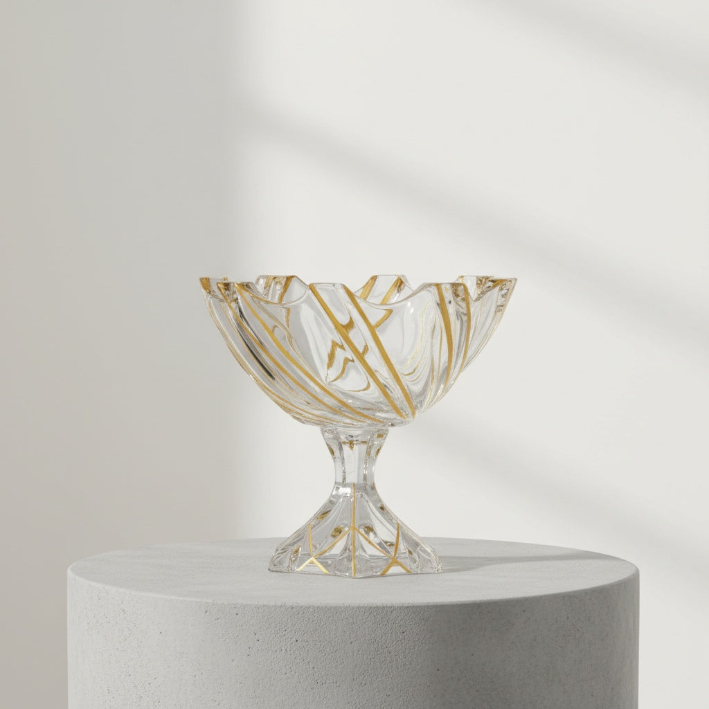 Gold veined crystal footed bowl with scalloped rim on wooden table