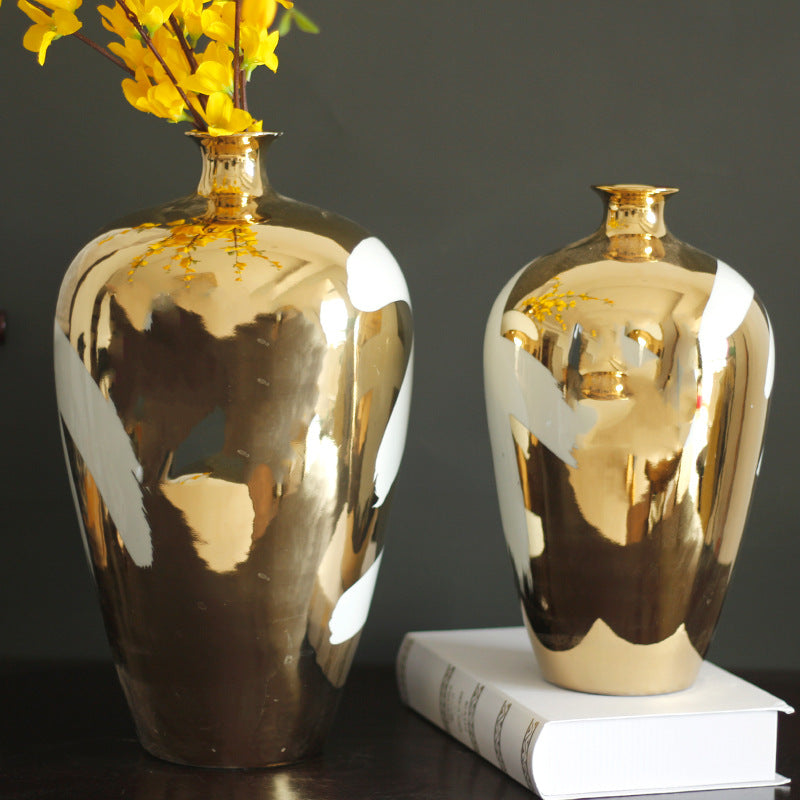Detail view of gold plating and white glaze on ceramic vase
