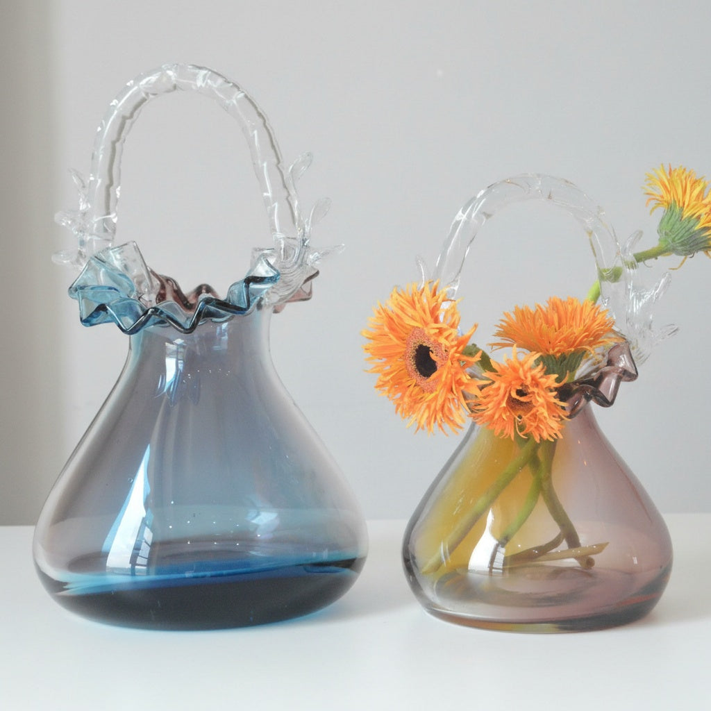 Two gradient art glass basket vases in blue and amber with ruffled rims