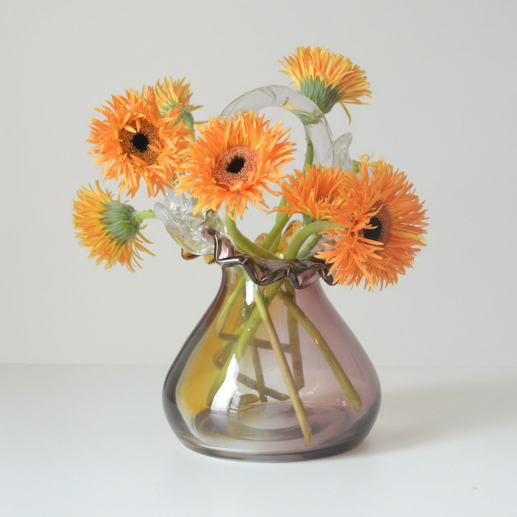 Amber and purple gradient glass basket vase with orange flowers
