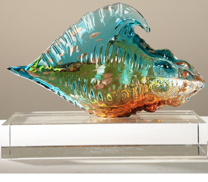 Side view of large teal and amber glass shell sculpture