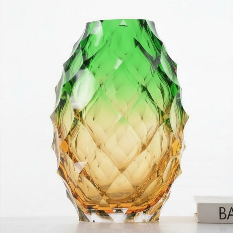 Front view of geometric faceted glass vase in green and amber gradient
