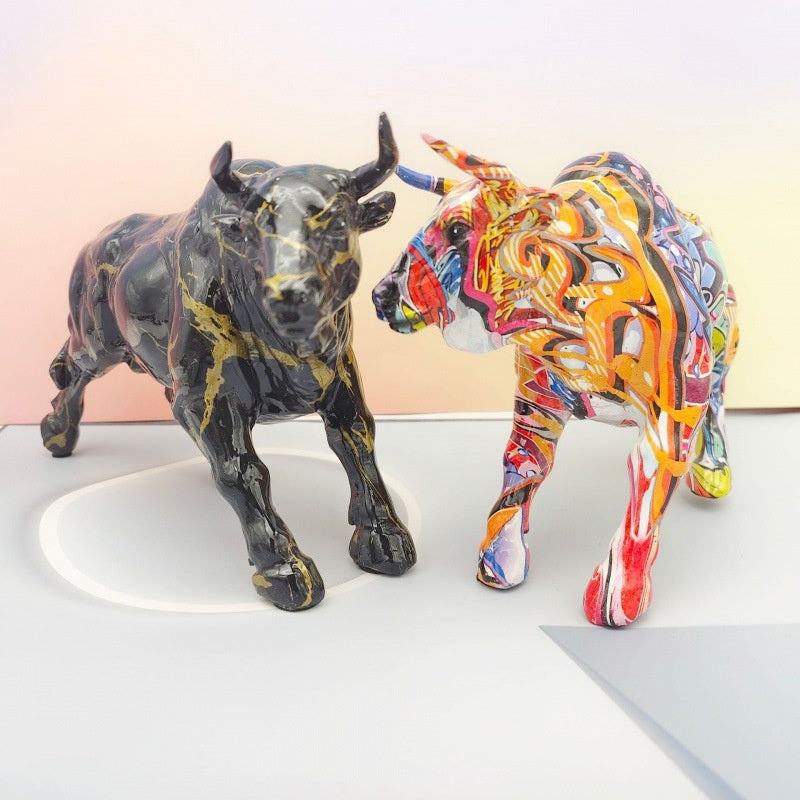 Group shot of black and graffiti bull sculptures