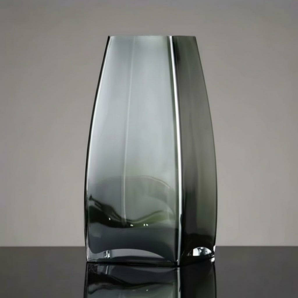 Empty graphite glass geometric vase against a neutral background