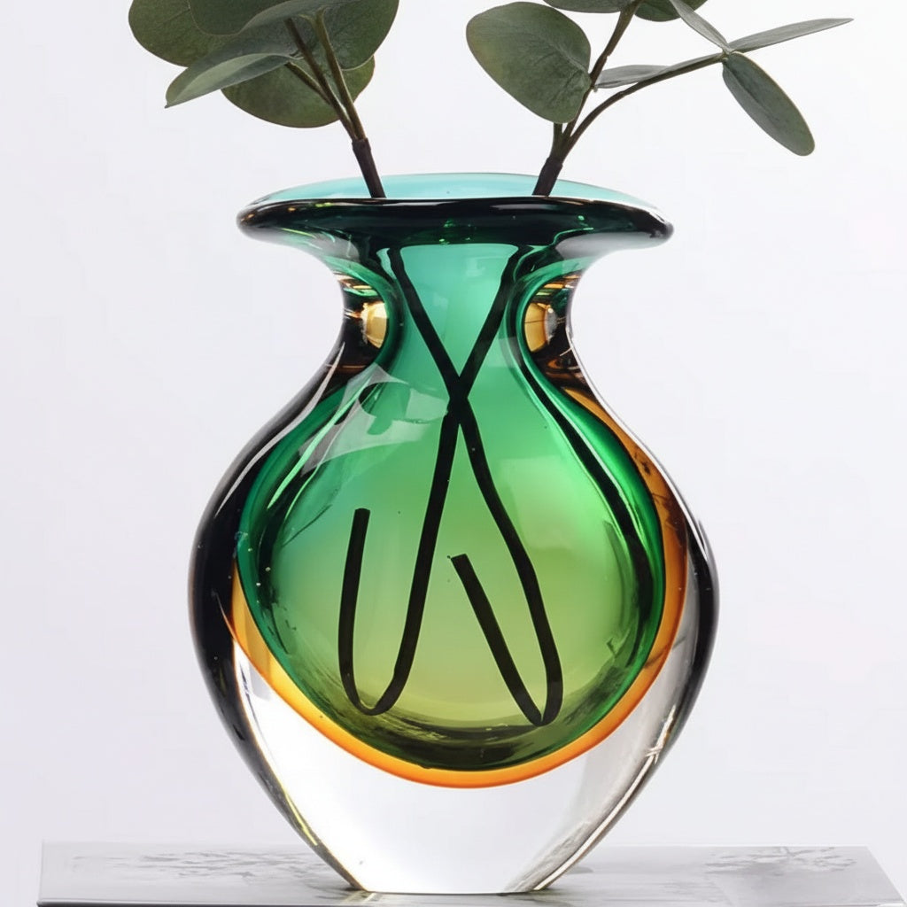 Art glass vase with eucalyptus stems showing scale