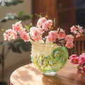 Art glass nautilus shell vase with pink flowers