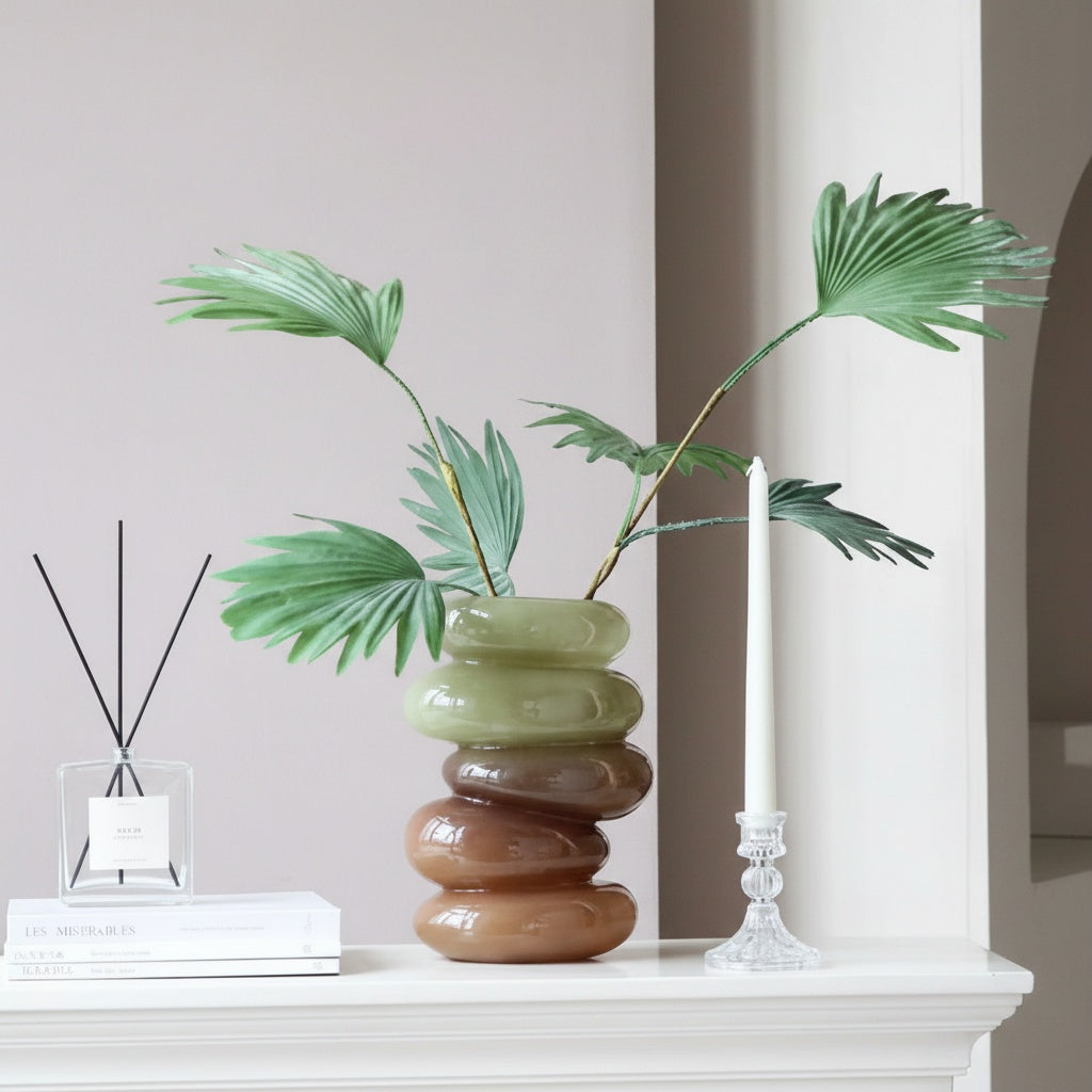 Green and amber stacked glass vase with palm leaves