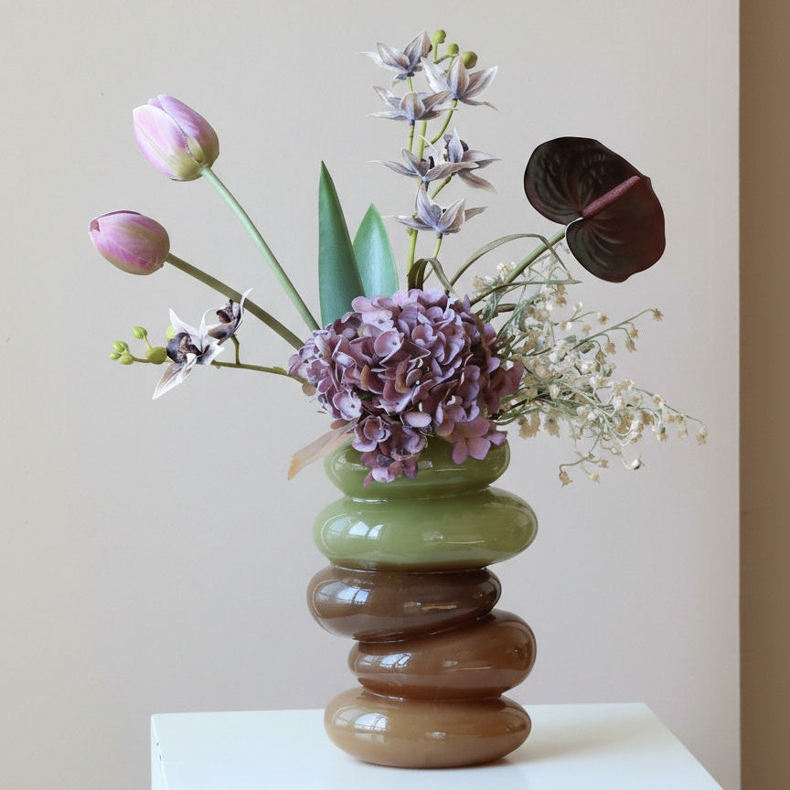 Stacked pebble glass vase with tulips and hydrangeas