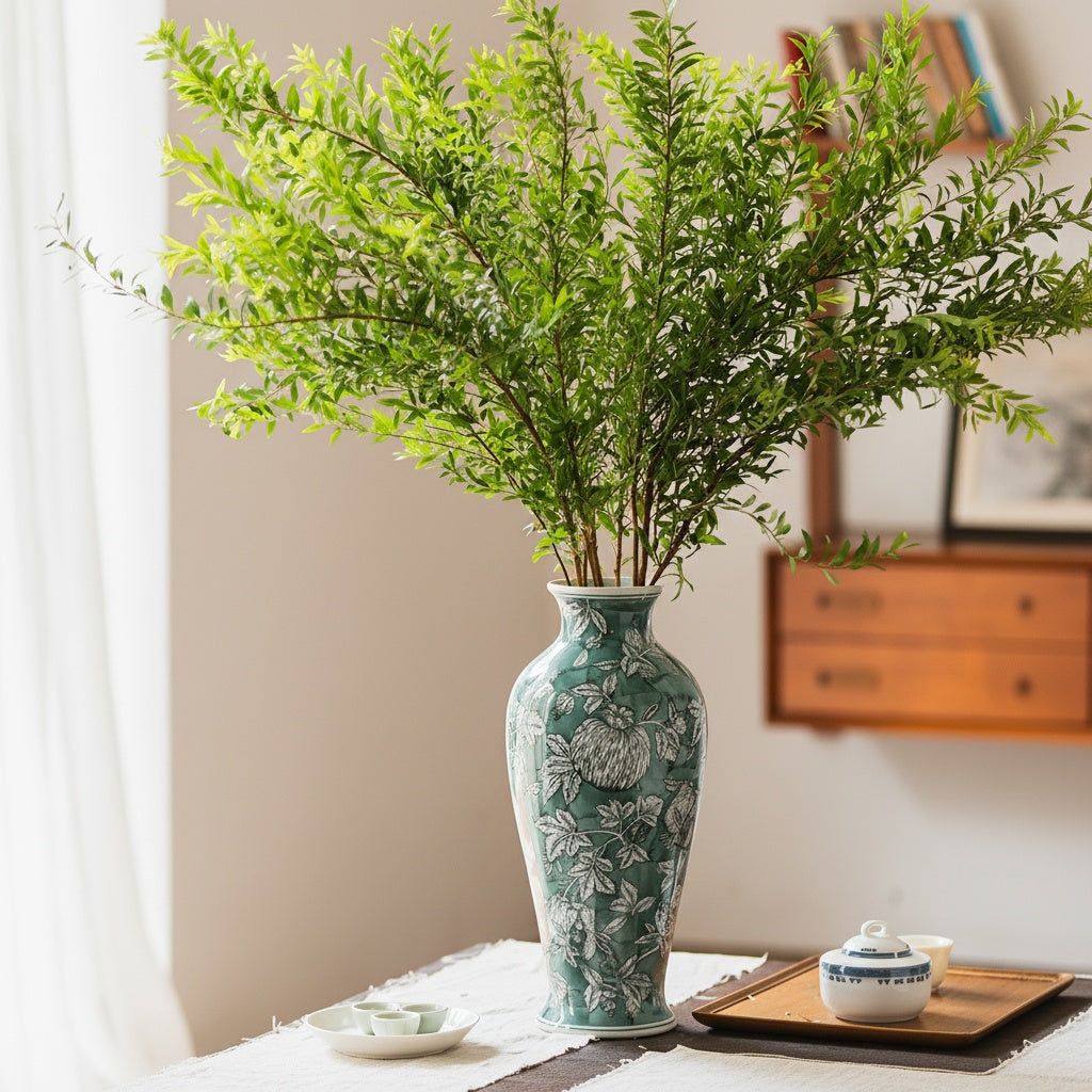 Green And White Botanical Ceramic Vase styled with fresh greenery on a table