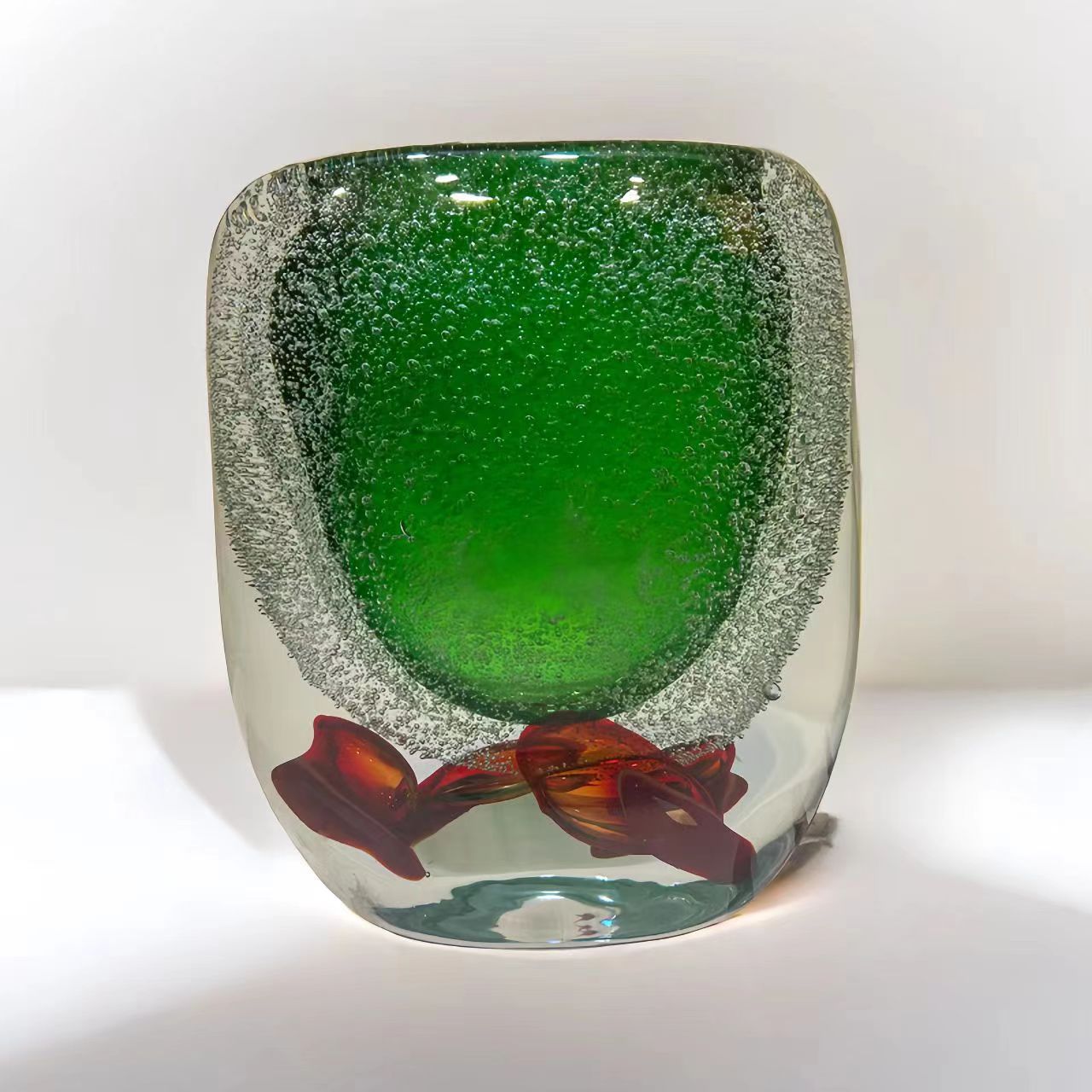 Studio shot of medium green glass vase with suspended bubbles