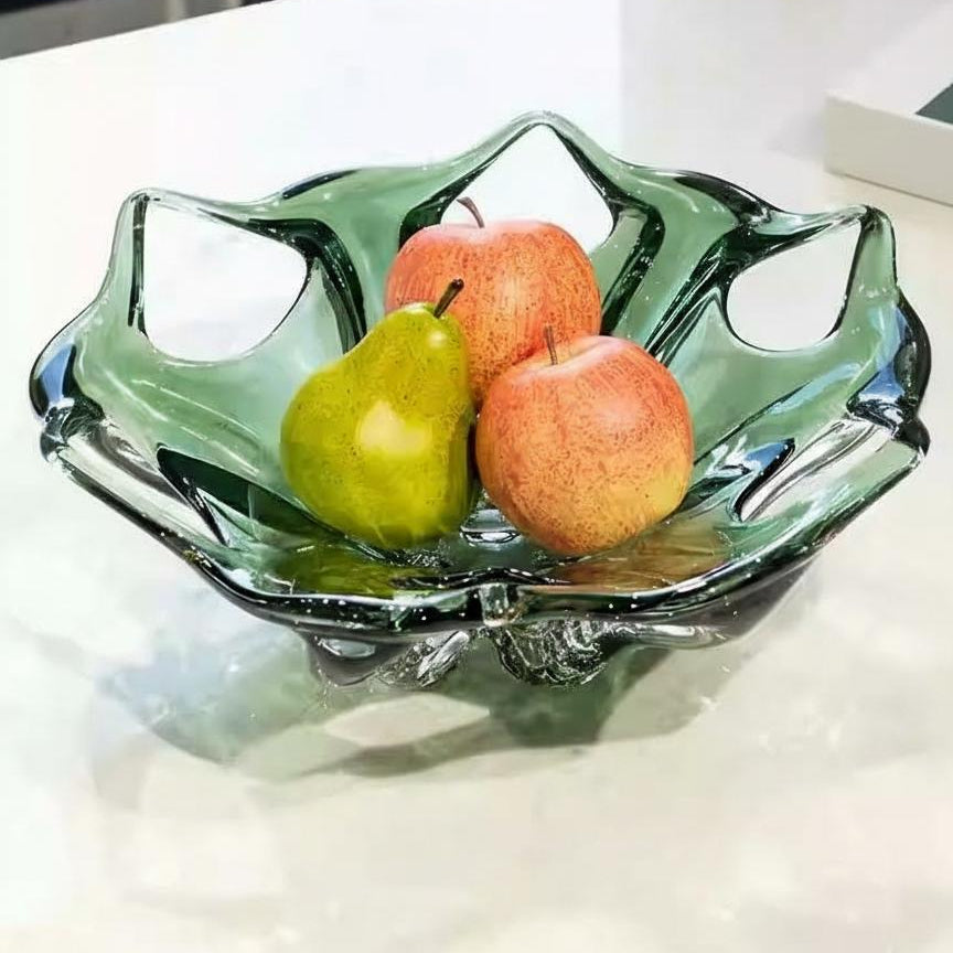 Green colored glaze sculptural centerpiece bowl with fruit on table