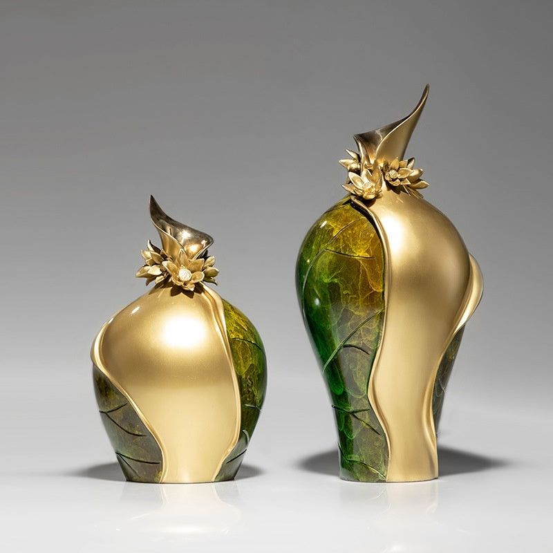Two green and gold sculptural vases standing together