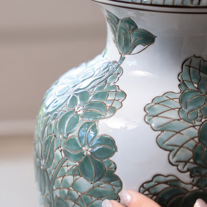 Close up detail of green floral patterns on ceramic vase