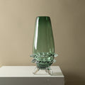 Tall green glass vase with clear textured base detail