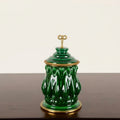 Front view of green glazed ceramic jar with brass finial