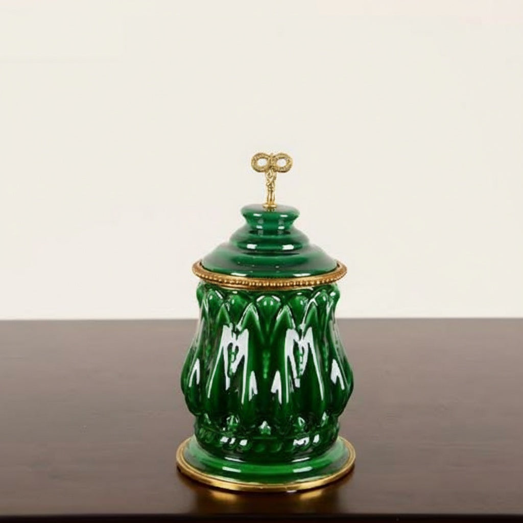Front view of green glazed ceramic jar with brass finial