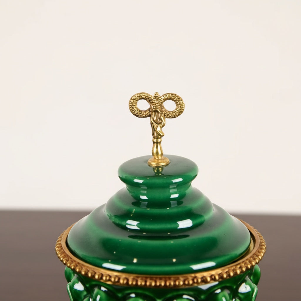 Close up detail of brass finial on green ceramic lid