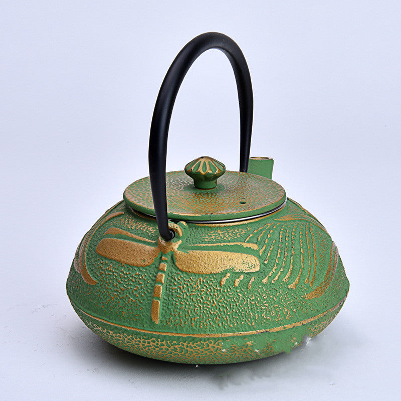 Front view of green cast iron teapot showing texture and lid