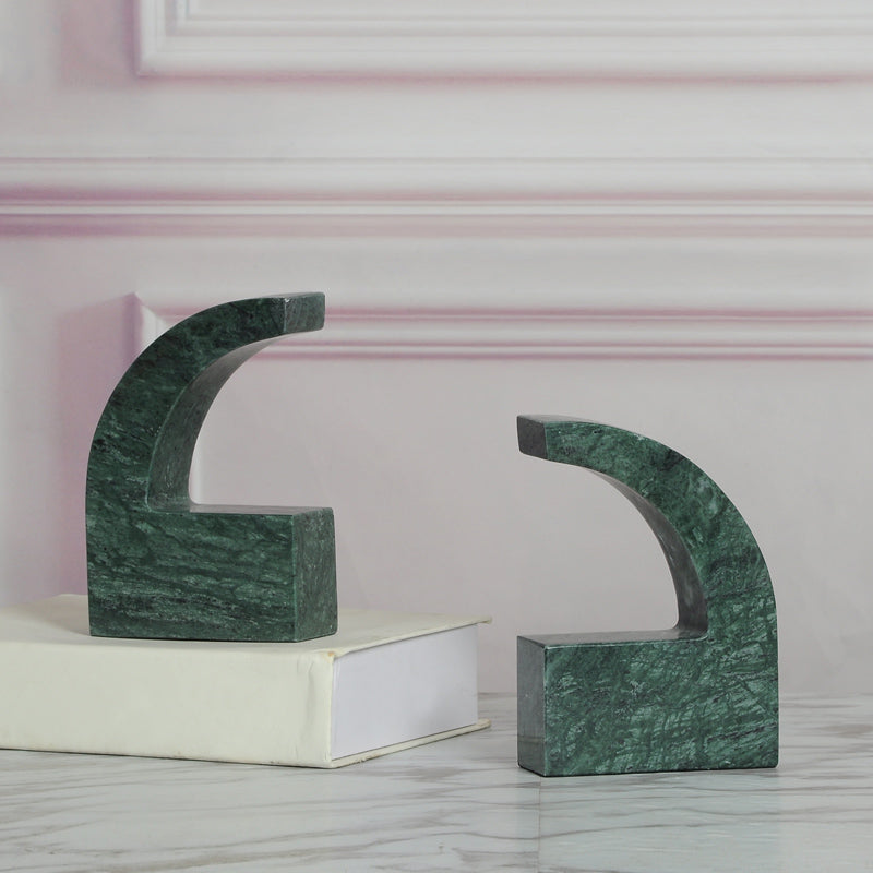 Side view of green marble bookends showing geometric arch shape and polished stone finish