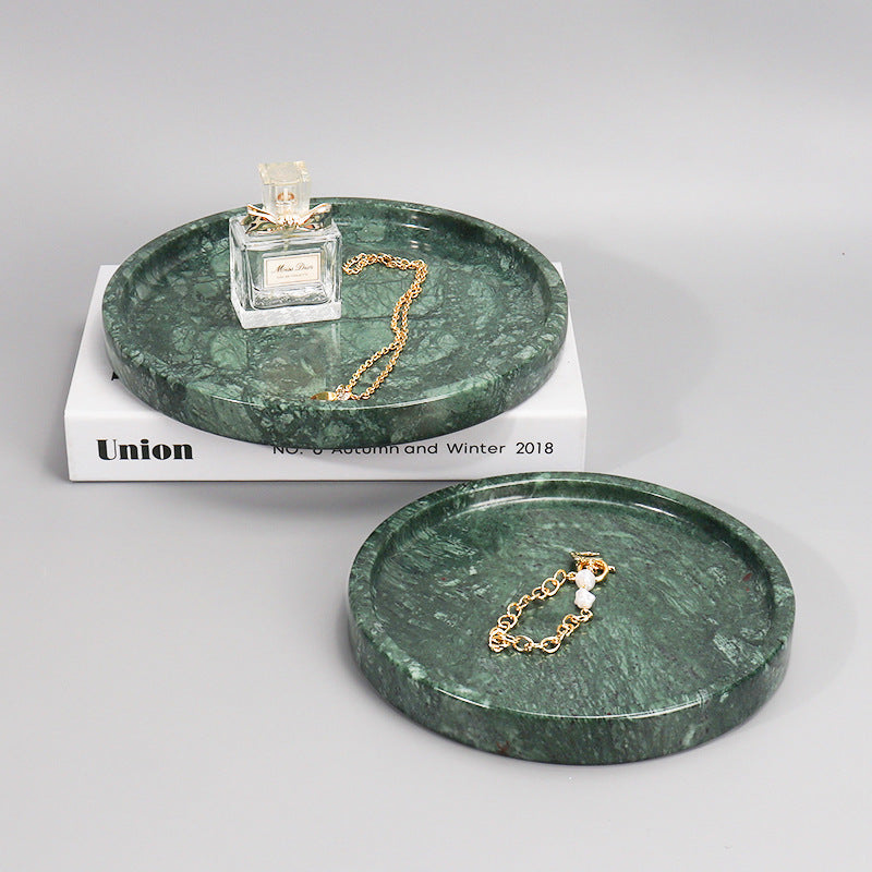Green marble round vanity trays styled with perfume and jewelry
