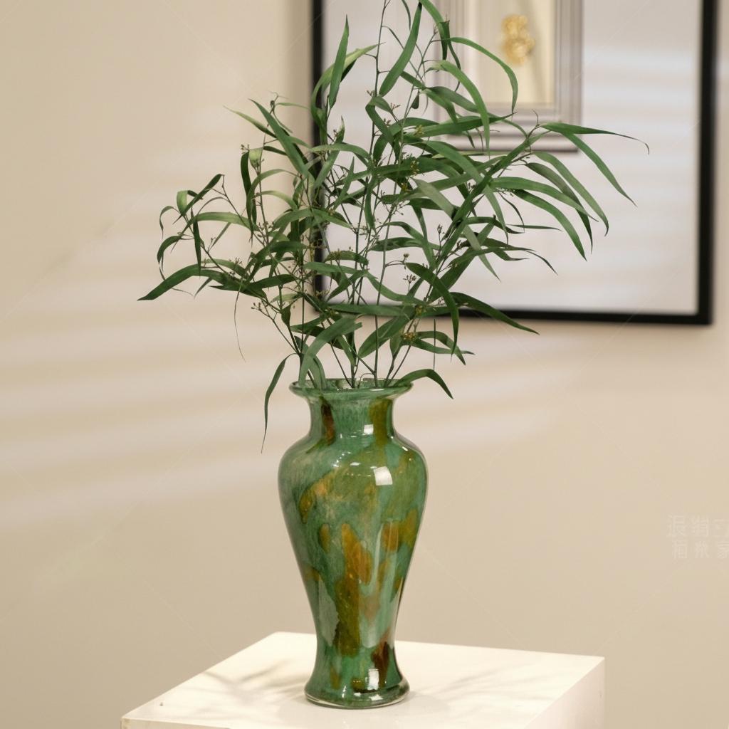 Green marbled glass vase with leafy foliage