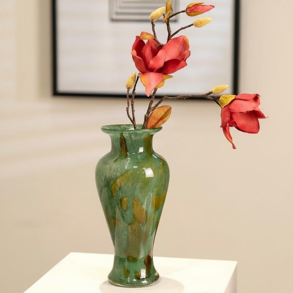 Green marbled glass vase with magnolia flowers