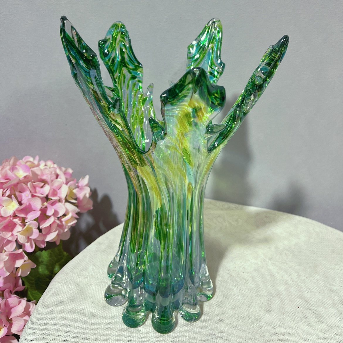 Tall organic shape green speckled glass vase