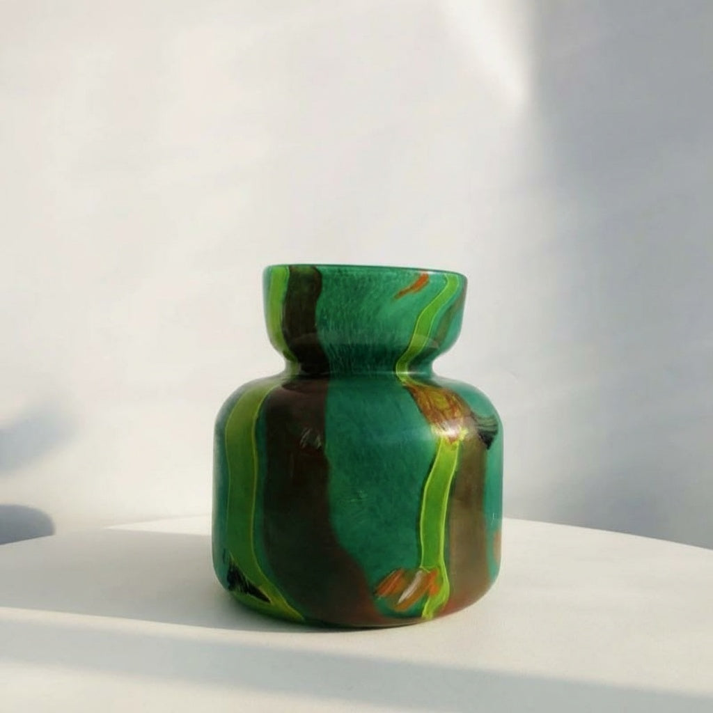 Front view of green swirled art glass vase