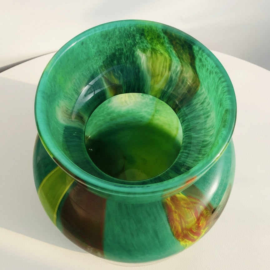Top down view into green glass vase interior