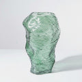 Solo shot of tall green textured glass vase