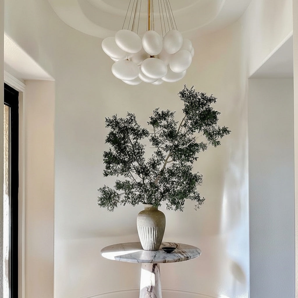 Large grey ribbed vase in entryway on marble table
