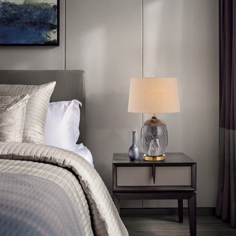 Grey marble ceramic lamp on bedside table