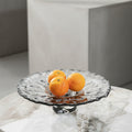 Grey textured glass pedestal fruit bowl with oranges