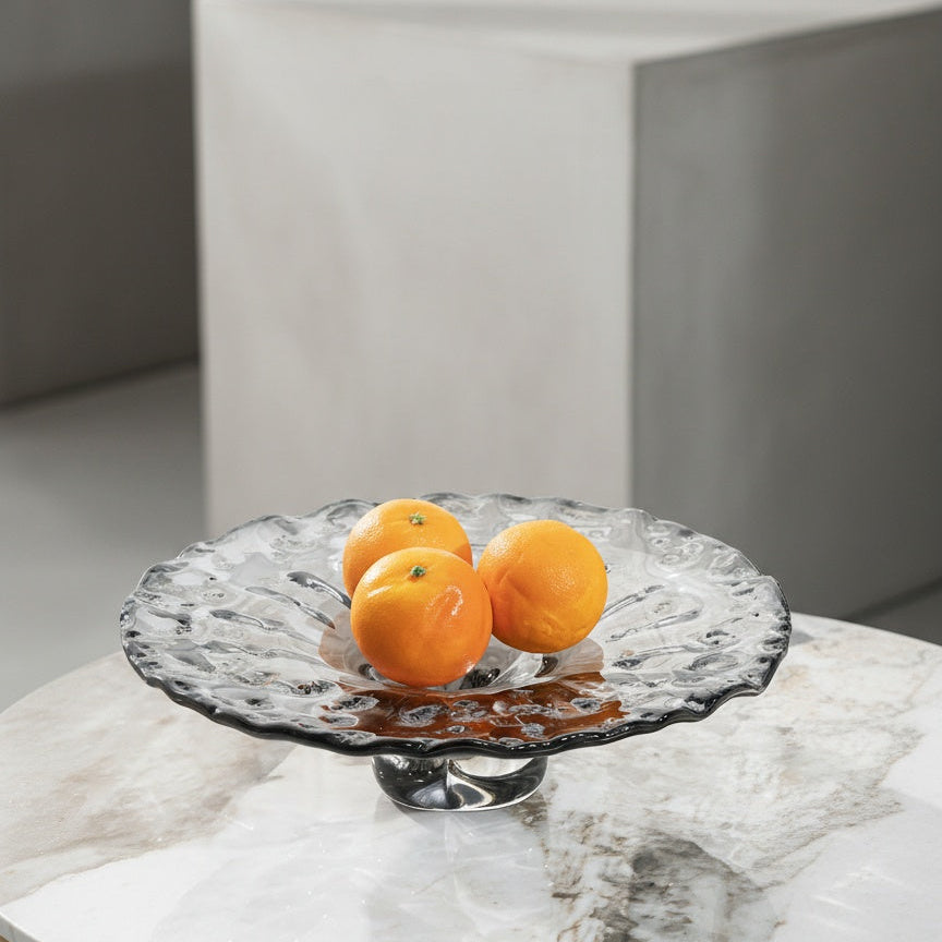 Grey textured glass pedestal fruit bowl with oranges