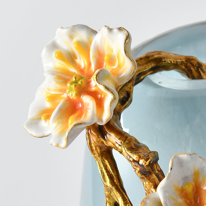 Close up of enamel flower and gold branch detail